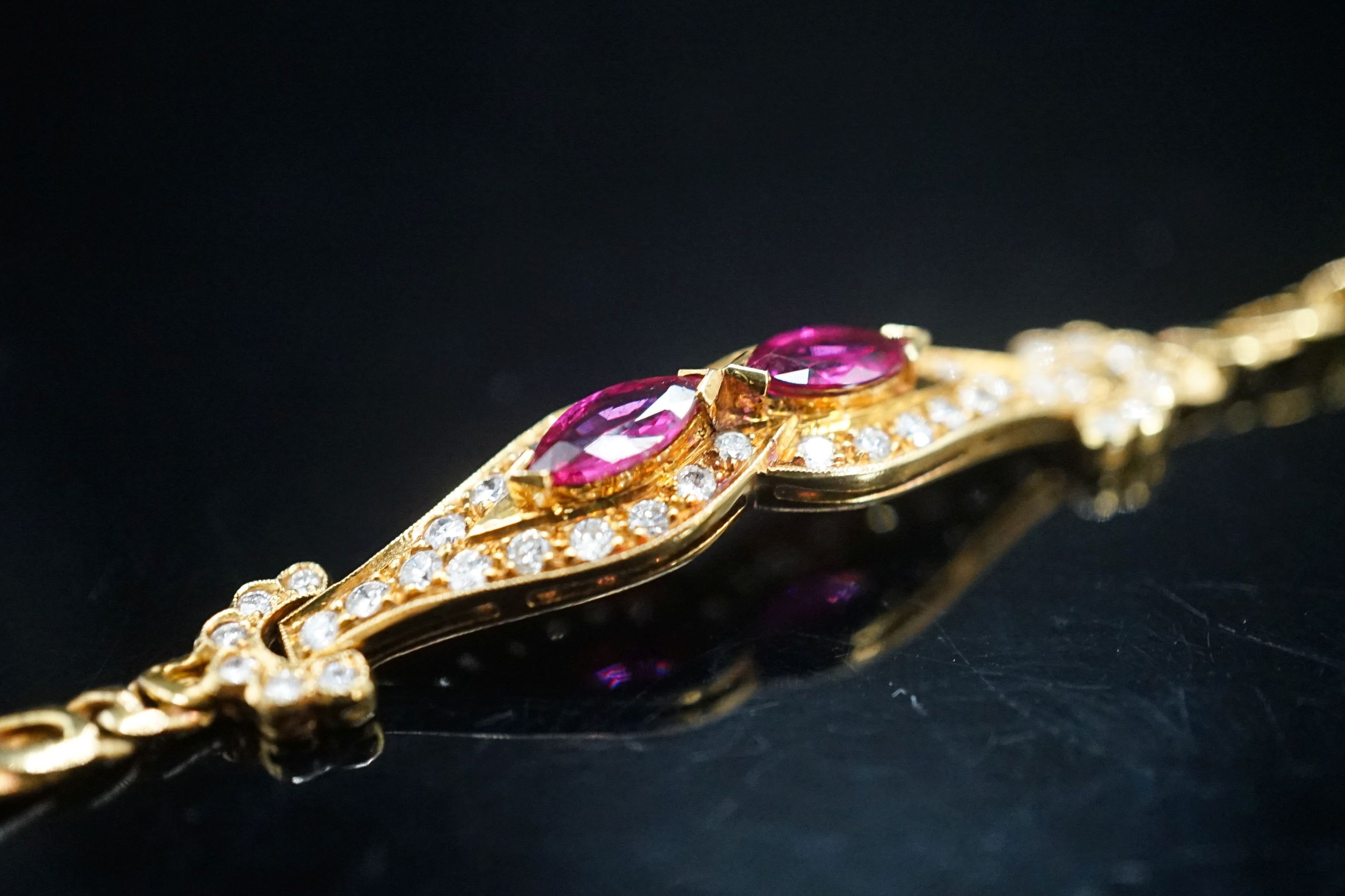 A lady's modern 18k, ruby and diamond set bracelet, 16cm, gross weight 9.2 grams.